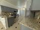 Updated kitchen with granite countertops, stainless steel appliances, and stylish backsplash at 143 Glasgow Ct, Davenport, FL 33897
