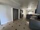 Bright kitchen with stainless steel refrigerator, tile flooring and a large pantry at 143 Glasgow Ct, Davenport, FL 33897