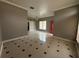 Spacious living room displaying tile floors, neutral wall paint, a window, and an open layout at 143 Glasgow Ct, Davenport, FL 33897