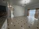 Large open-concept room with tile flooring, sliding glass doors and kitchen view with breakfast bar at 143 Glasgow Ct, Davenport, FL 33897