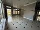 Bright living room featuring tiled floors, large windows, neutral paint, and decorative ceiling trim at 143 Glasgow Ct, Davenport, FL 33897