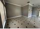 Neutral living room showing tile floors, neutral walls, decorative trim, and large windows with blinds at 143 Glasgow Ct, Davenport, FL 33897
