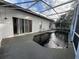 Screened pool with concrete deck and adjacent to sliding glass doors for easy indoor-outdoor living at 143 Glasgow Ct, Davenport, FL 33897