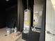 Utility area with a water heater and HVAC unit, showcasing essential home systems at 143 Glasgow Ct, Davenport, FL 33897