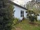 View of side yard with ADT security sign near the house at 143 Glasgow Ct, Davenport, FL 33897