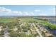 Aerial view of residential area with green spaces, ponds, and single-Gathering homes under a blue sky at 1534 Gants Cir, Kissimmee, FL 34744