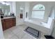 Bathroom with granite vanity and soaking tub at 1534 Gants Cir, Kissimmee, FL 34744