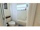 This bathroom has a tub and shower combination with a white tile surround at 1534 Gants Cir, Kissimmee, FL 34744