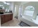 Bathroom featuring a garden tub, double vanity, and tile floors at 1534 Gants Cir, Kissimmee, FL 34744