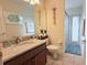 The bathroom features a granite vanity, tile flooring, and a separate tub/shower at 1534 Gants Cir, Kissimmee, FL 34744