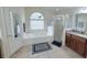 Bathroom featuring a garden tub, walk-in shower, double vanity, and tile floors at 1534 Gants Cir, Kissimmee, FL 34744