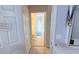 Hallway view into the bathroom with a toilet and tiled floors at 1534 Gants Cir, Kissimmee, FL 34744