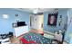 Bright bedroom featuring a car shaped bed, light blue walls, and a ceiling fan at 1534 Gants Cir, Kissimmee, FL 34744