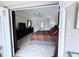 View of the main bedroom featuring tray ceilings, tile floors, and dark wood furnishings at 1534 Gants Cir, Kissimmee, FL 34744