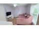 Bedroom with light purple walls, pink day bed, white curtains and furniture at 1534 Gants Cir, Kissimmee, FL 34744