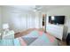 This bedroom has wood laminate flooring, a ceiling fan and a double door closet at 1534 Gants Cir, Kissimmee, FL 34744