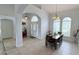 Inviting dining area with modern chandelier and a view of the large windows and beautiful front yard at 1534 Gants Cir, Kissimmee, FL 34744