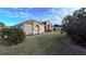 Tan house with a walkway, neatly kept lawn and mature shrubs at 1534 Gants Cir, Kissimmee, FL 34744