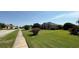 Exterior view of a well-landscaped home with lush greenery and a neatly maintained lawn on a sunny day at 1534 Gants Cir, Kissimmee, FL 34744