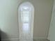 Hallway leading to the bathroom with an arched doorway at 1534 Gants Cir, Kissimmee, FL 34744