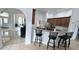 Open kitchen with breakfast bar, granite countertops, and stainless steel appliances at 1534 Gants Cir, Kissimmee, FL 34744