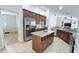 An open kitchen featuring stainless steel appliances, granite countertops, a center island, and lots of counter space at 1534 Gants Cir, Kissimmee, FL 34744