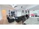 Spacious living room with entertainment center, ceiling fan, and open access to the sunroom at 1534 Gants Cir, Kissimmee, FL 34744