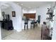 Open-concept living space with tile flooring, bar seating, and seamless transitions to other rooms at 1534 Gants Cir, Kissimmee, FL 34744