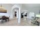Open-concept living space with tiled floors, neutral paint, and architectural columns providing a modern feel at 1534 Gants Cir, Kissimmee, FL 34744