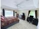 Spacious bedroom featuring a large window, ceiling fan, and dark wood furniture at 1534 Gants Cir, Kissimmee, FL 34744