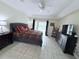 Spacious main bedroom with tile floors, dark wood furniture and ensuite at 1534 Gants Cir, Kissimmee, FL 34744