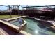 Gorgeous screened-in pool and spa with lush landscaping for a private and tranquil outdoor experience at 1534 Gants Cir, Kissimmee, FL 34744