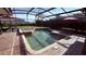 Private screened-in pool and spa surrounded by lush landscaping for a serene and relaxing outdoor space at 1534 Gants Cir, Kissimmee, FL 34744