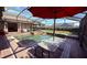 Private screened-in pool and spa with an outdoor dining area, ideal for summer barbecues and relaxation at 1534 Gants Cir, Kissimmee, FL 34744