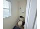 Powder room featuring a toilet, vanity, and decorative wall art at 1534 Gants Cir, Kissimmee, FL 34744