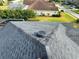 Close-up view of gray asphalt shingle roof with solar powered attic fan, showcasing ventilation system at 1534 Gants Cir, Kissimmee, FL 34744