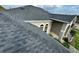 Durable roof with a modern design and light-colored gutters, seen on a sunny day at 1534 Gants Cir, Kissimmee, FL 34744