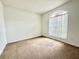 Well-lit bedroom featuring brown carpet and a large window at 1558 Indian Oaks Trl, Kissimmee, FL 34747