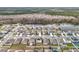 Community overview featuring houses with solar panels and a lake at 1634 Reddish Egret Ct, Davenport, FL 33897