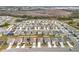 Aerial view of neighborhood with houses near a pond at 1634 Reddish Egret Ct, Davenport, FL 33897