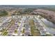 Aerial view of neighborhood with houses near a pond at 1634 Reddish Egret Ct, Davenport, FL 33897