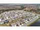 Aerial view of neighborhood with houses near a pond at 1634 Reddish Egret Ct, Davenport, FL 33897