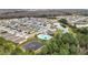 Aerial perspective of houses, a community pool, and lush greenery at 1634 Reddish Egret Ct, Davenport, FL 33897