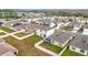 Aerial view of houses with fenced backyards and solar panels at 1634 Reddish Egret Ct, Davenport, FL 33897