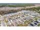 Community overview featuring houses with solar panels and a lake at 1634 Reddish Egret Ct, Davenport, FL 33897