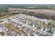 Community overview featuring houses with solar panels and a lake at 1634 Reddish Egret Ct, Davenport, FL 33897