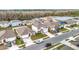 Community overview featuring houses with solar panels and a lake at 1634 Reddish Egret Ct, Davenport, FL 33897