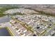 Aerial view of a new residential community with houses, ponds, and lush green areas at 1634 Reddish Egret Ct, Davenport, FL 33897