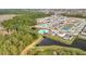Aerial view of a residential area with a community pool and pond at 1634 Reddish Egret Ct, Davenport, FL 33897