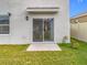 Private backyard with sliding glass door access at 1634 Reddish Egret Ct, Davenport, FL 33897